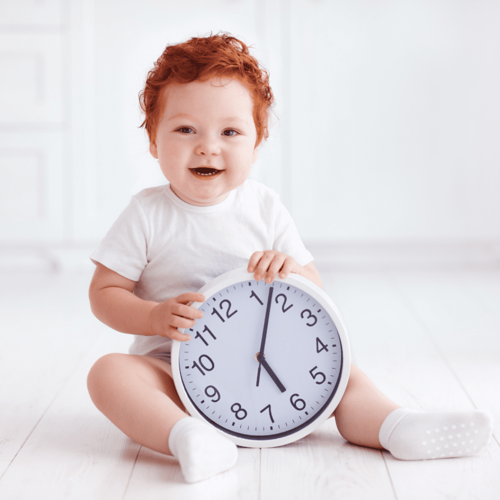 Main image for the article [Why a little hunger is NOT an emergency]. Pictured is a toddler holding a clock.