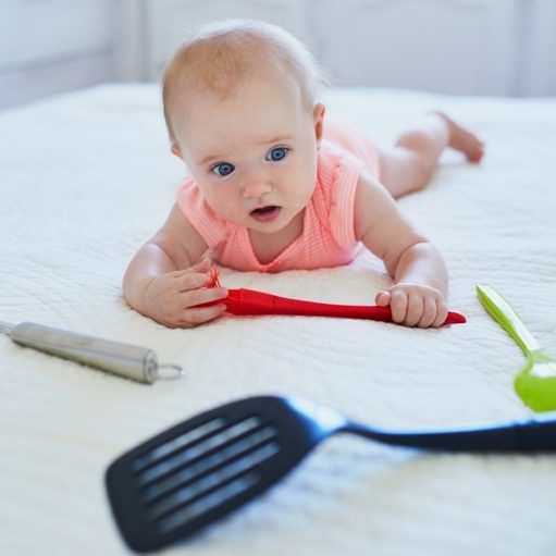 baby with adult utensils, spoon and forks