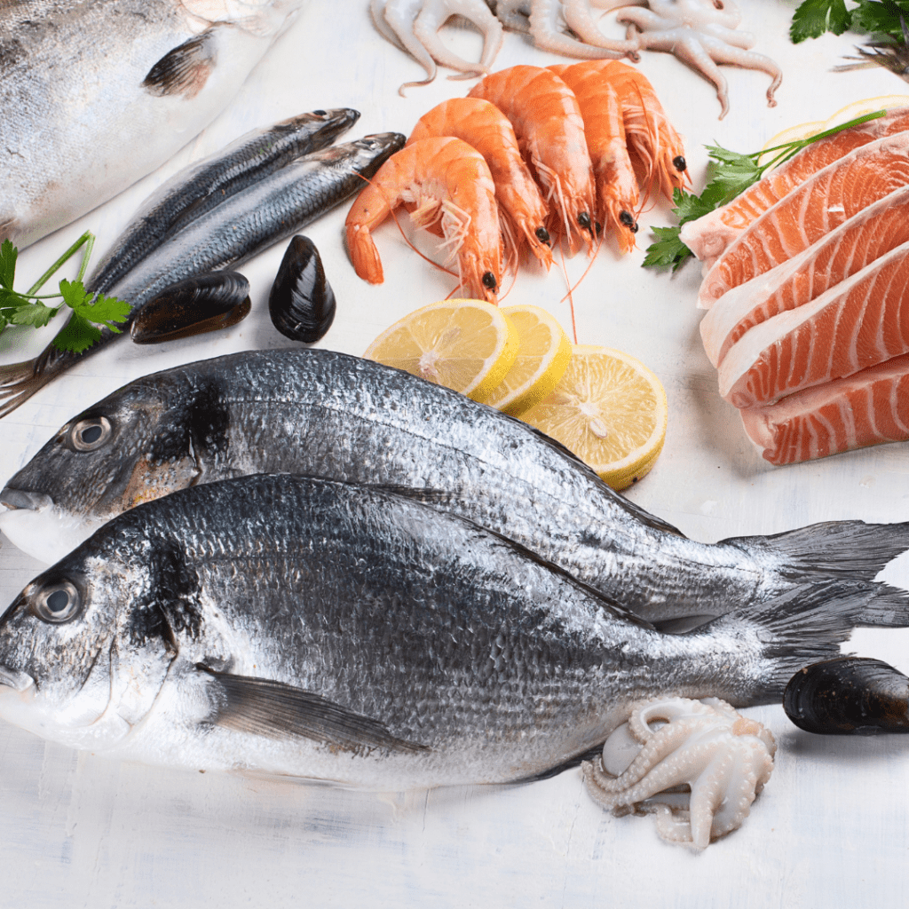 Featured image for the article: "The ultimate guide to the safest fish for your baby." Pictured is a variety of fish and seafood.