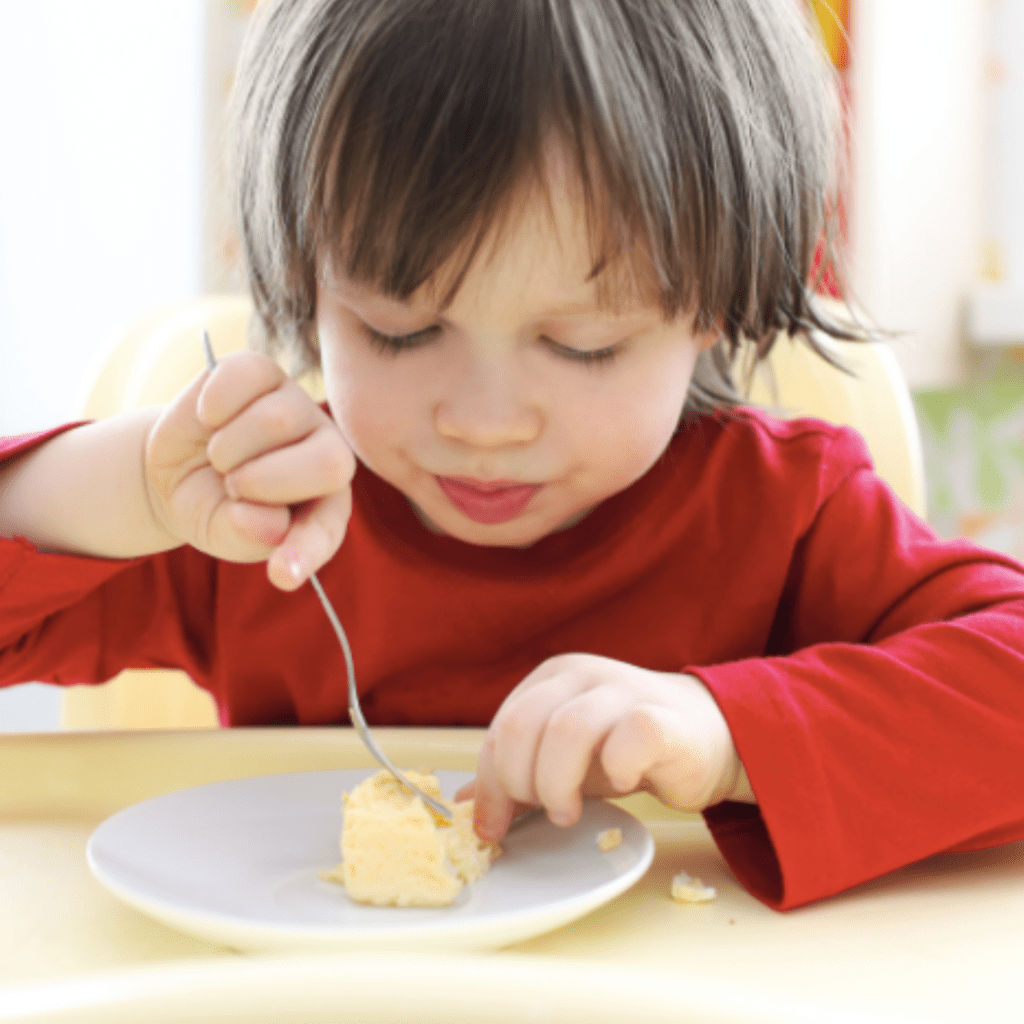 Episode art for episode "#47:Everything to know about eggs for your baby & toddler." Pictured is a toddler eating scrambled eggs.