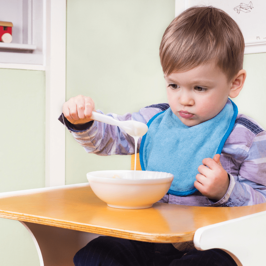 Episode art for episode: “#74: Live Q&A! Solutions for a mom of a picky eater who only eats a few foods.” Pictured is a toddler holding a spoon and not eating.