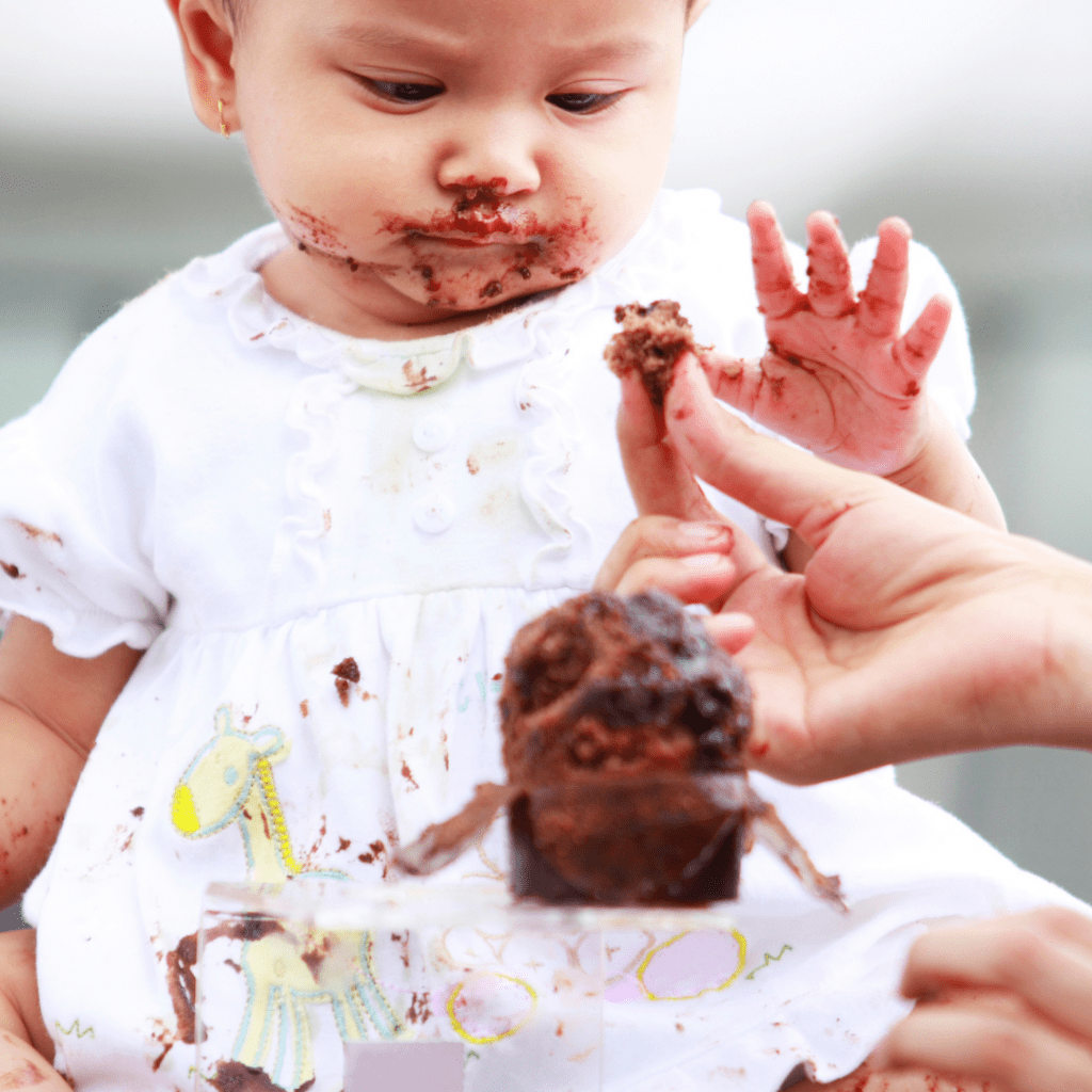 baby eating cake