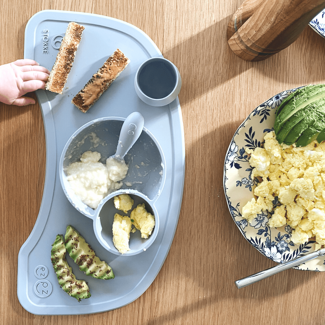 healthy toddler meal consisting of eggs, nut butter toast, yogurt and avocado